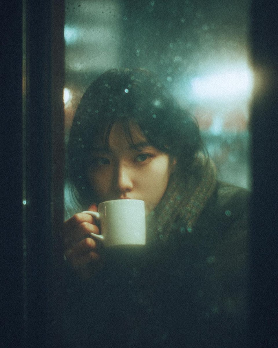AI portrait prompt example — moody portrait of a woman with a mug behind a rain-covered café window at night